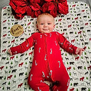 Remington joined the competition — help win amazing prizes! baby, infant, red_onesie, candy_cane_pattern, poinsettia, holiday_decor, blanket, animal_print, wooden_sign, four_months, smiling, lying_down, cute, festive, christmas_theme, child, indoors, portrait, happy, toddler