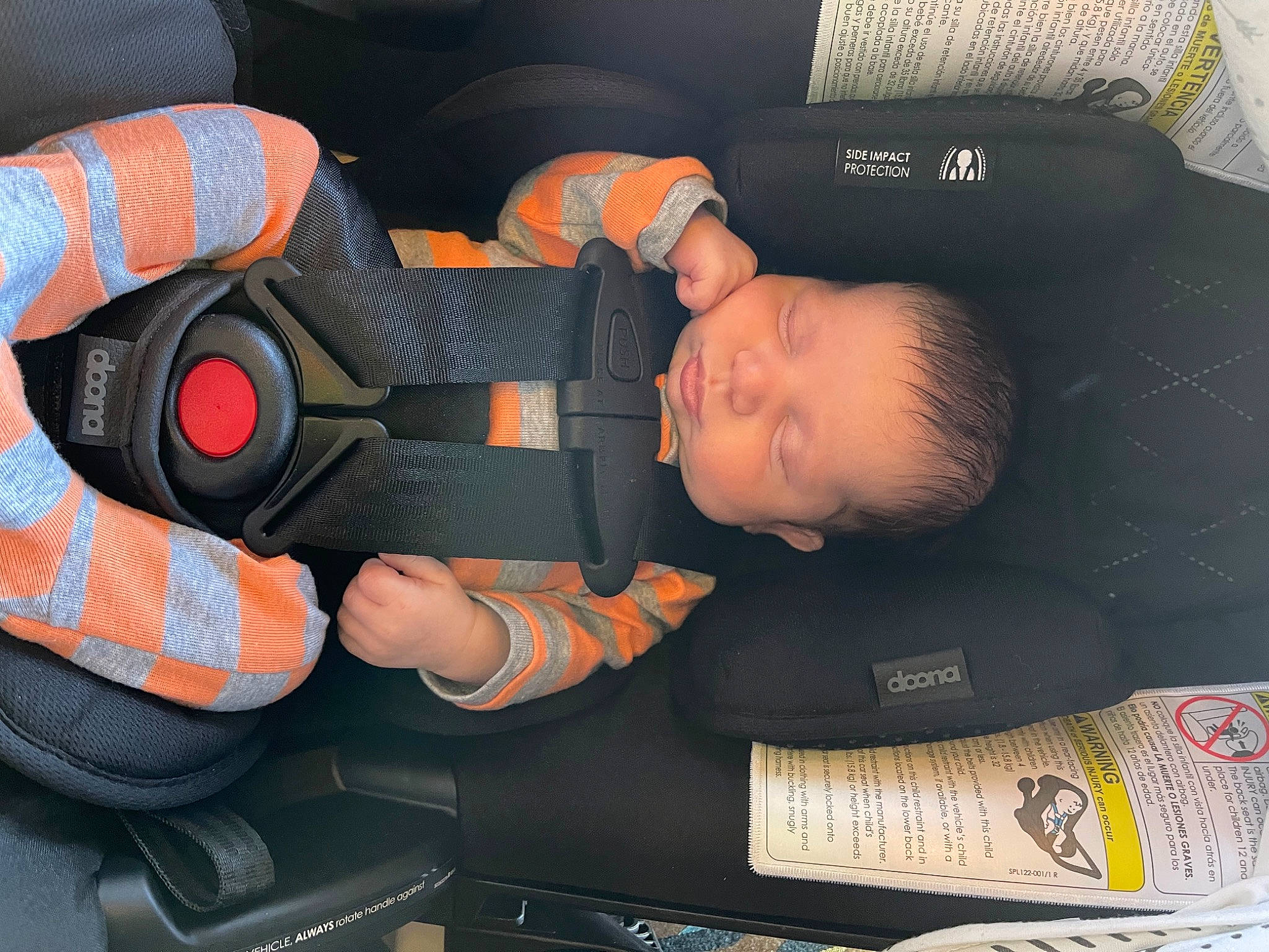 Saint is registered to the contest to win money with this photo: auto_part, automotive_design, automotive_wheel_system, baby, baby_carriage, baby_in_car_seat, baby_products, baby_toddler_clothing, car_seat, carmine, child, comfort, finger, fun, head, orange, person, personal_protective_equipment, thumb, toddler