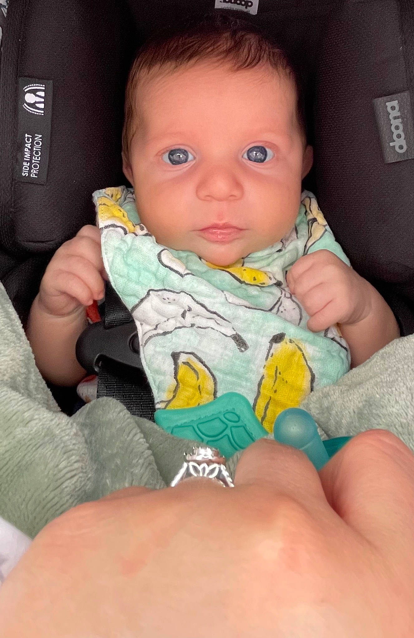 Saint is registered to the contest to win money with this photo: arm, baby, baby_toddler_clothing, cheek, child, comfort, eye, finger, hand, iris, lap, lip, mouth, nail, neck, nose, person, sitting, skin, thumb