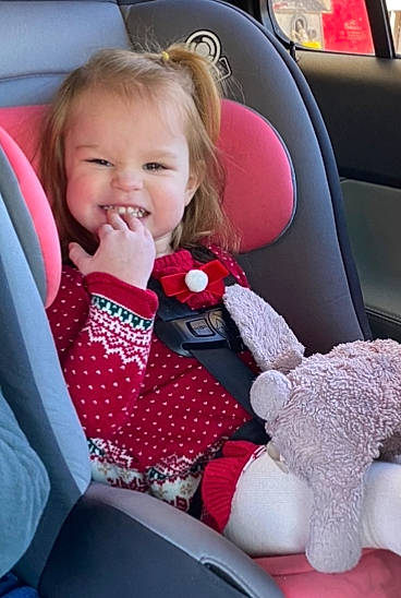 Emily joined the competition — help win amazing prizes! auto_part, automotive_design, automotive_exterior, baby_toddler_clothing, car, car_seat, car_seat_cover, comfort, happy, head_restraint, motor_vehicle, person, pink, product, smile, steering_part, steering_wheel, toddler, toy, vehicle_door