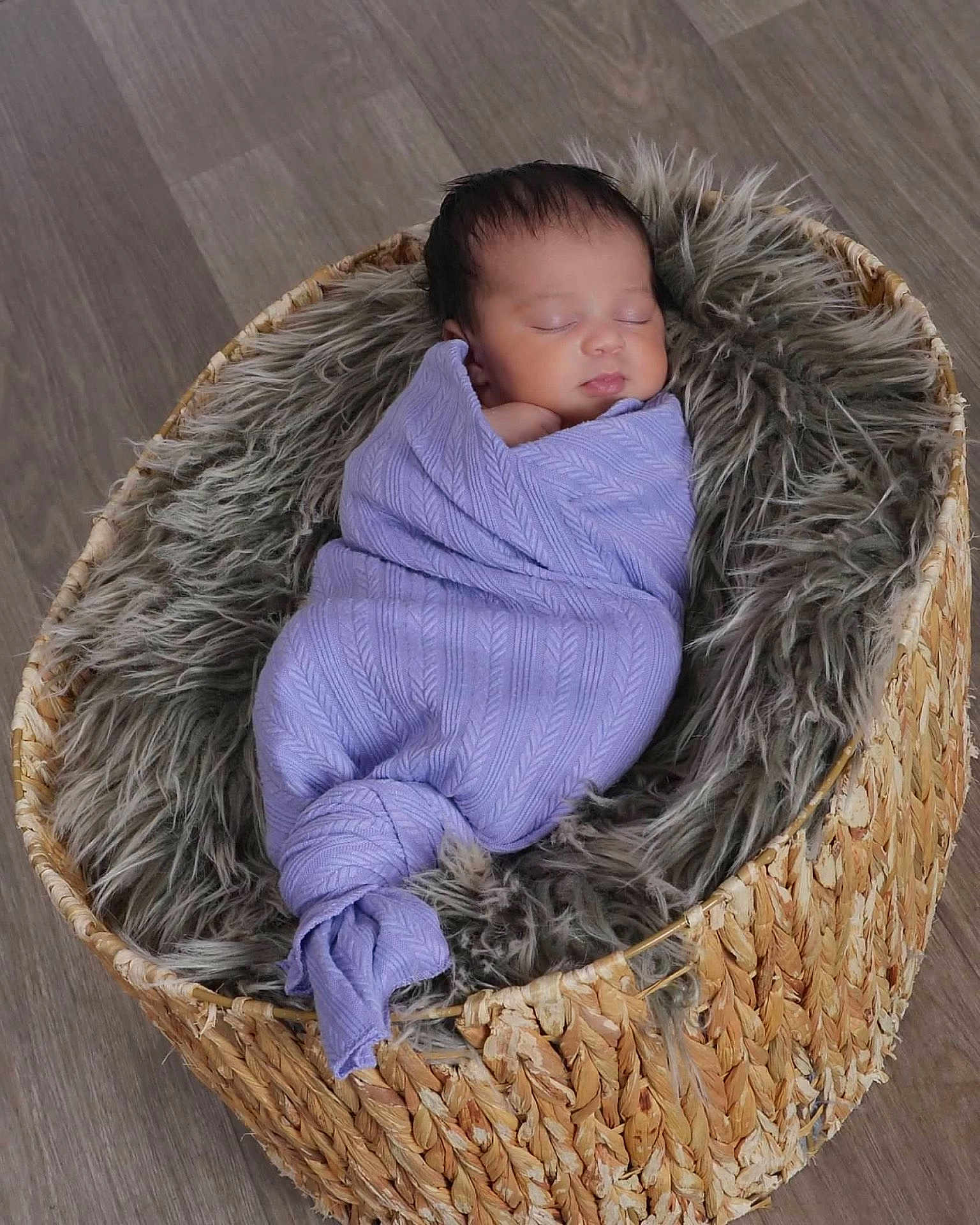 Aria is registered to the contest to win money with this photo: baby, newborn, sleeping, wrapped, blanket, basket, fur, floor, cozy, peaceful, infant, child, indoors, portrait, cute, soft, purple, woven, resting, head