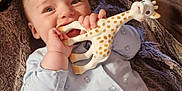 Alfred joined the competition — help win amazing prizes! baby, baby_toy, blanket, chewing, child, cozy, cute, giraffe_toy, happy, indoor, infant, light_blue_clothing, lying_down, onesie, portrait, small_hands, smiling, soft_texture, teddy_bear_print, teething_toy