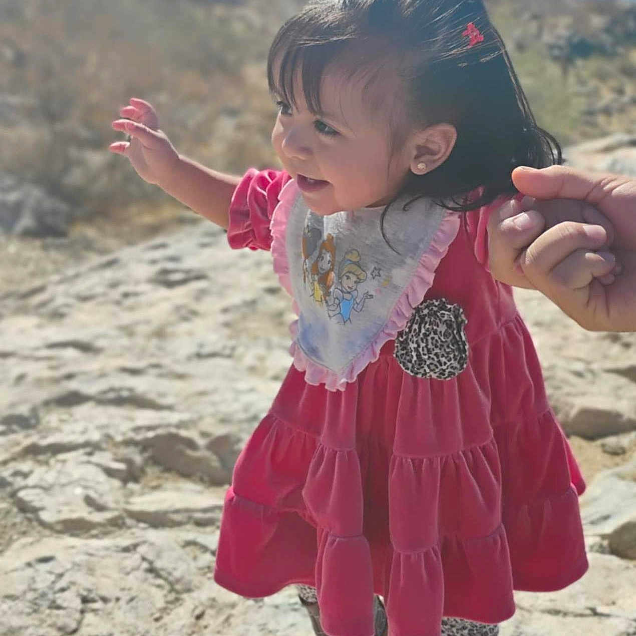 Anthonella is registered to the contest to win money with this photo: bodypart, child, clothing, dress, face, female, finger, girl, hand, happy, head, nature, outdoors, person, photography, portrait, rock, sitting, sleeve, smile