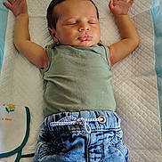 Jaden a rejoint le concours — aidez-le/la à gagner de superbes lots ! baby, sleeping, infant, jeans, green_shirt, arms_stretched, changing_pad, quilted, white_socks, soft_cloth, peaceful, indoors, child, cute, toddler, resting, casual_clothing, small_hands, relaxed, portrait