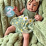 Layla joined the competition — help win amazing prizes! baby, infant, child, green_dress, headband, bow, blanket, fluffy, soft_texture, hand, legs, cute, portrait, laying_down, two_months, indoors, skin, face, eyes, expression
