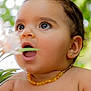 baby, child, face, portrait, closeup, jewelry, earrings, necklace, flower, nature, greenery, bokeh, skin, cute, expression, open_mouth, eyes, outdoor, adorable, young