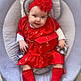 baby, infant, red_dress, headband, socks, baby_rocker, smiling, cute, child, indoor, portrait, happy, fashion, accessories, flooring, seat, person, young_child, headwear, casual