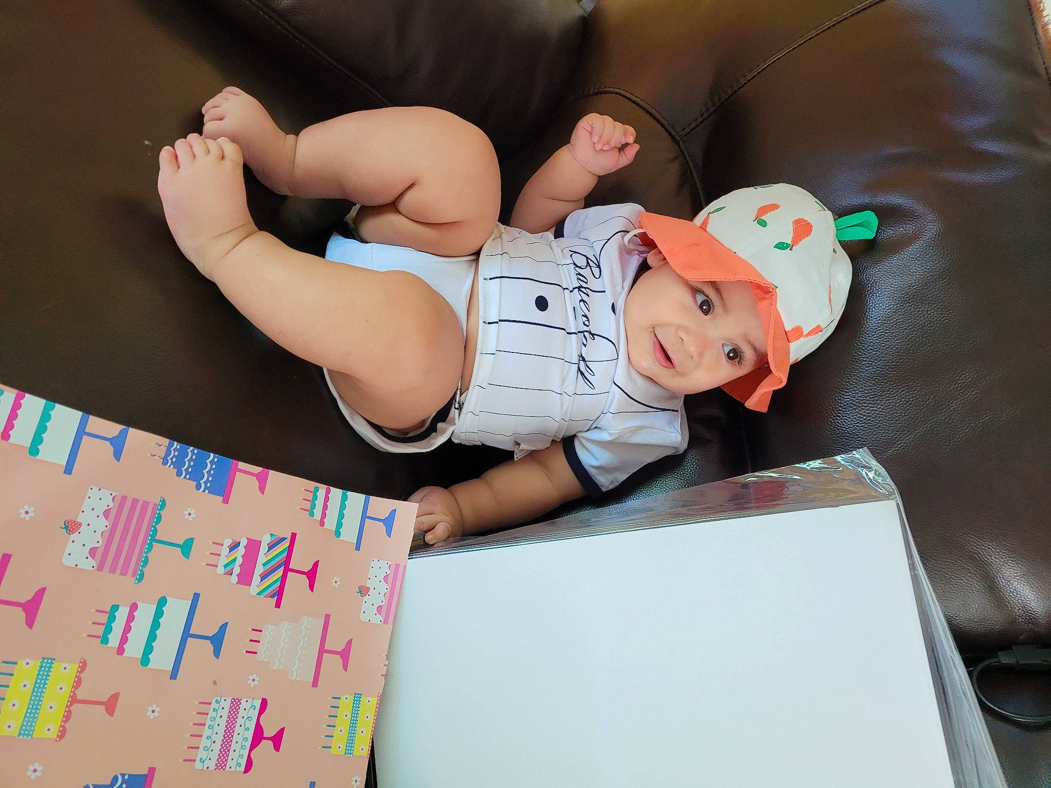 Iker is registered to the contest to win money with this photo: baby, baby_toddler_clothing, child, comfort, diaper, elbow, fun, hat, headwear, human_leg, knee, lap, leisure, paper_product, person, room, sock, stationery, t_shirt, thigh