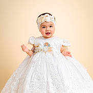 Alina is registered to the contest to win money with this photo: baby, child, dress, white_dress, lace, headband, flower, portrait, smiling, cute, studio, background, infant, girl, happiness, celebration, fashion, adorable, person, young