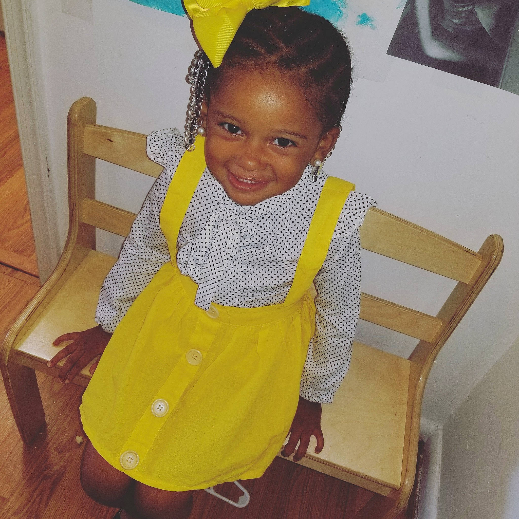 Peighton is registered to the contest to win money with this photo: adaptation, chair, child, dress, fashion_design, joy, person, room, sitting, smile, standing, toddler, yellow