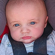 Liam joined the competition — help win amazing prizes! baby, face, blue_eyes, car_seat, safety_harness, infant, close_up, expression, child, skin, head, clothing, seatbelt, seat, cute, young, person, portrait, straps, serious
