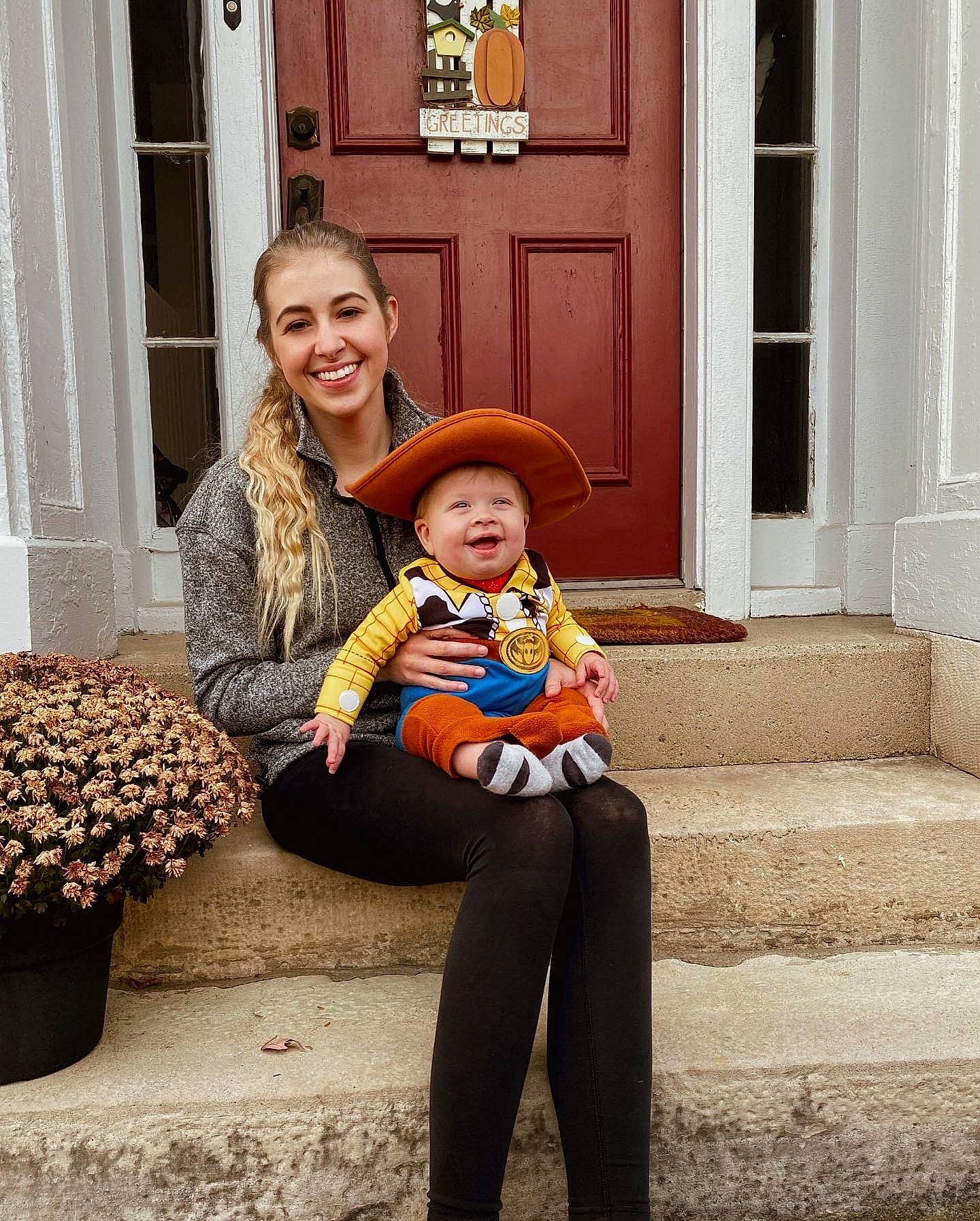 Jaxon is registered to the contest to win money with this photo: child, door, eye, face, flower, flowerpot, fun, happy, hat, head, headwear, human_leg, interaction, joy, orange, person, plant, sitting, smile, standing