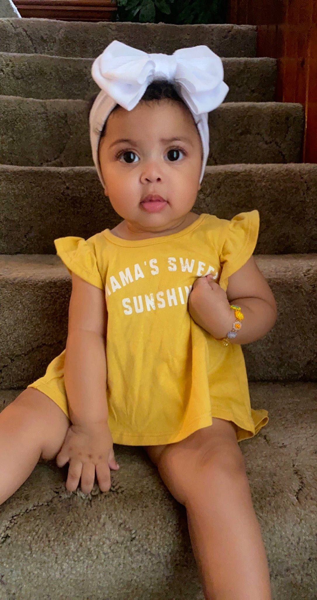 Amari is registered to the contest to win money with this photo: baby, baby_toddler_clothing, cheek, costume_hat, eye, eyelash, face, facial_expression, finger, hair, happy, head, headwear, person, pink, skin, sleeve, standing, t_shirt, thigh