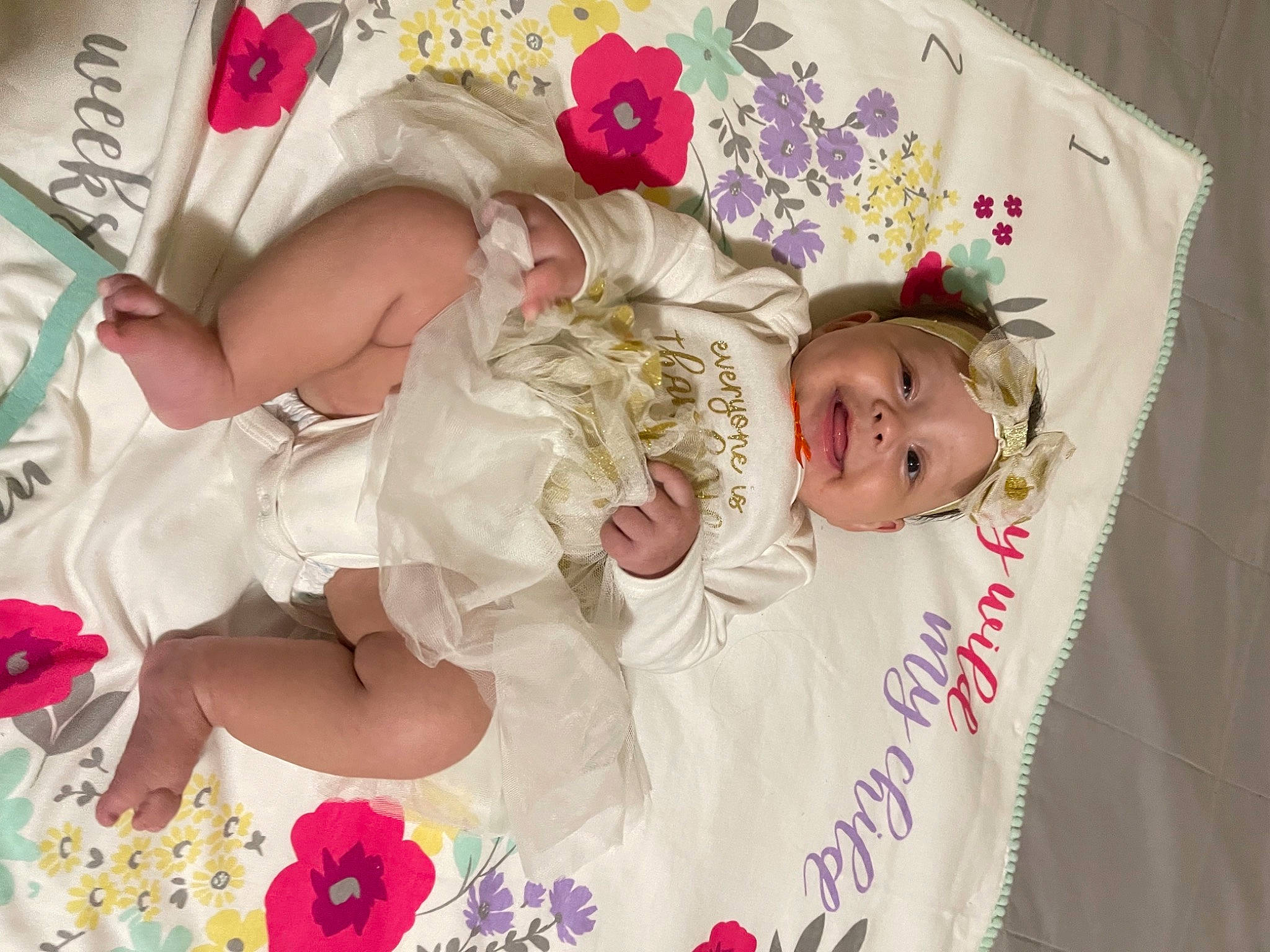 Kinzley is registered to the contest to win money with this photo: baby, baby_toddler_clothing, beauty, child, face, flower, hair_accessory, happy, headgear, headpiece, headwear, joy, magenta, pattern, person, petal, pink, skin, sleeve, smile