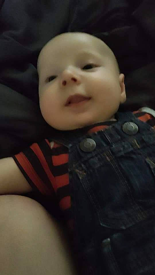 Elijah is registered to the contest to win money with this photo: baby, baby_toddler_clothing, cheek, comfort, cool, eye, eyebrow, finger, flash_photography, happy, iris, mammal, mouth, nose, outerwear, person, skin, sleeve, smile, textile