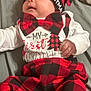 baby, infant, child, plaid, red, black, hat, bow_tie, clothing, holiday, christmas, bed, blanket, soft_lighting, cute, smiling, face, person, indoors, festive