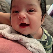 Liam joined the competition — help win amazing prizes! baby, smiling, face, hair, blanket, clothing, person, infant, cute, portrait, happy, indoors, child, young, skin, expression, candid, soft, warm, cozy