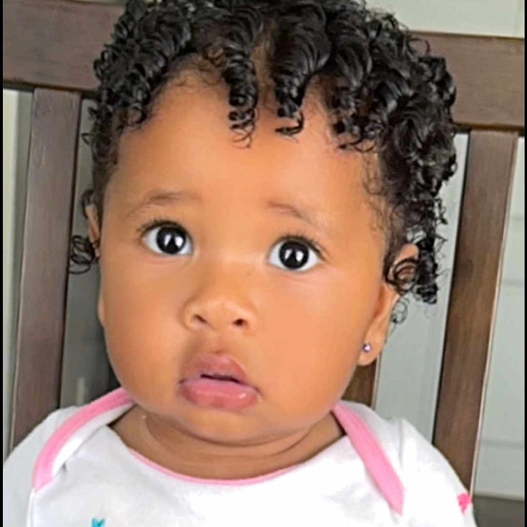 Royalty is registered to the contest to win money with this photo: baby, blackhair, bodypart, cornrows, curlyhair, face, hair, haircut, hairdresser, head, person, sad, shoulder, skin, surprised
