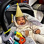 Jude participe au concours pour gagner de l'argent avec cette photo : baby, car_seat, party_hat, toy, smile, happy, indoor, child, clothing, blanket, infant, person, cute, face, seat, plaything, colorful, joyful, cozy, expression