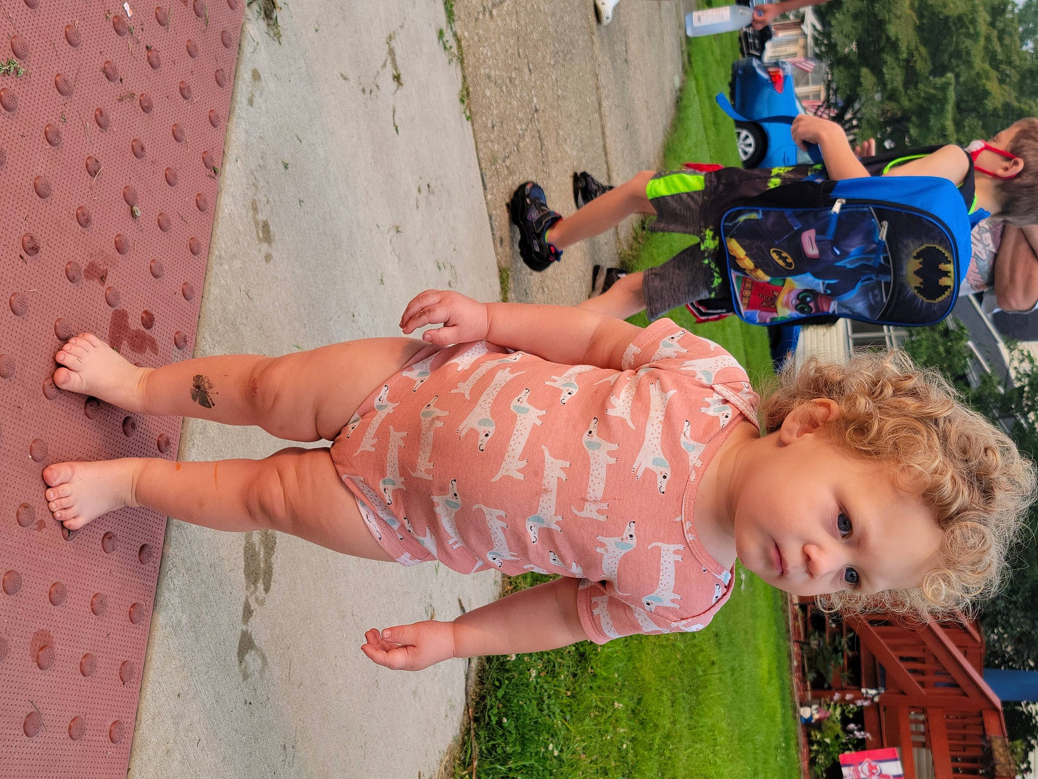 Dailyn is registered to the contest to win money with this photo: baby, child, clothing, fun, grass, happy, human_leg, leisure, orange, person, photograph, pink, public_space, recreation, sandal, shorts, snapshot, thigh, tire, toddler
