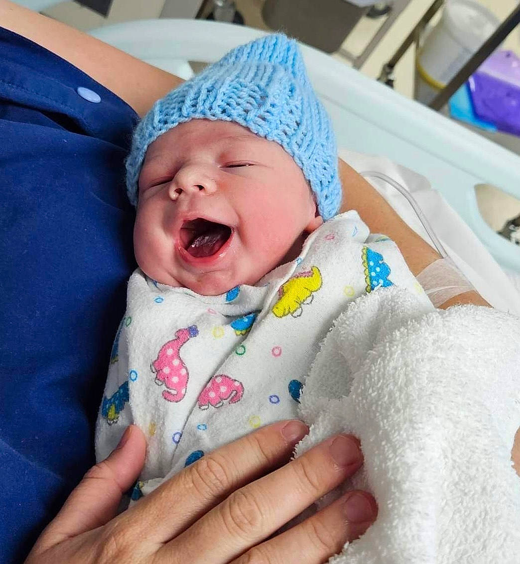Dustin is registered to the contest to win money with this photo: baby, baby_products, baby_sleeping, baby_toddler_clothing, cap, cheek, child, comfort, event, fashion_accessory, finger, gesture, happy, hat, headwear, linens, nail, person, skin, smile