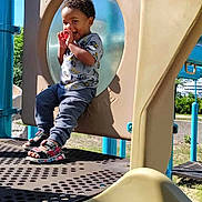 Zavion joined the competition — help win amazing prizes! toddler, child, playground, play_structure, slide, outdoor, smiling, happy, sunny, daytime, blue_sky, clothing, sandals, grass, trees, metal, plastic, fun, park, person