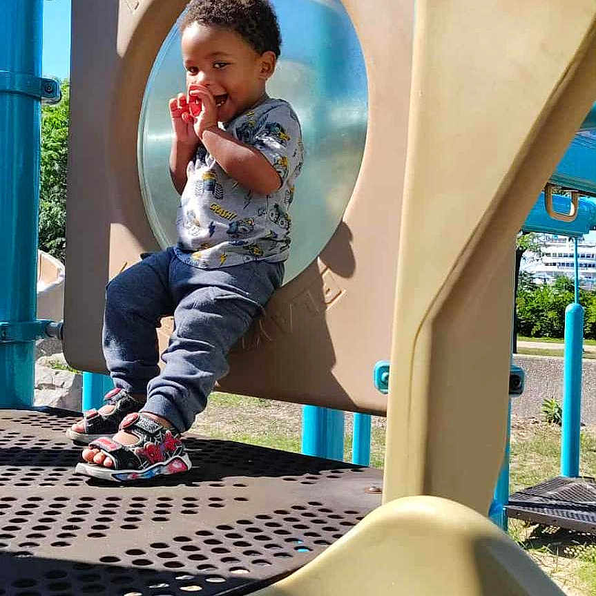 Zavion joined the competition — help win amazing prizes! blue_sky, child, clothing, daytime, fun, grass, happy, metal, outdoor, park, person, plastic, play_structure, playground, sandals, slide, smiling, sunny, toddler, trees