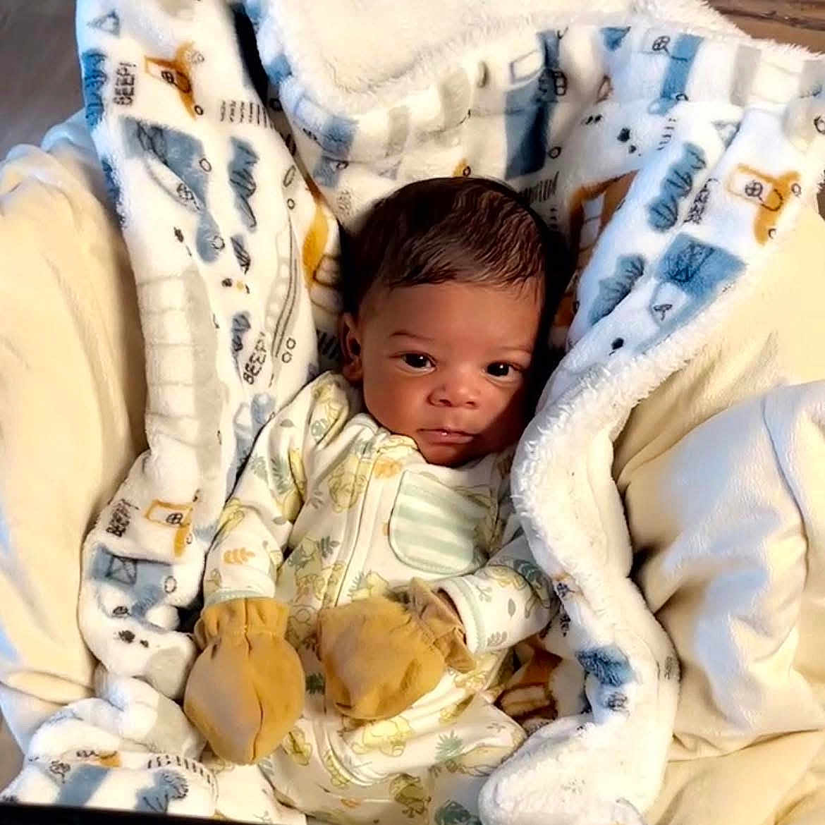 Blair is registered to the contest to win money with this photo: baby, blanket, crib, face, furniture, head, infantbed, person