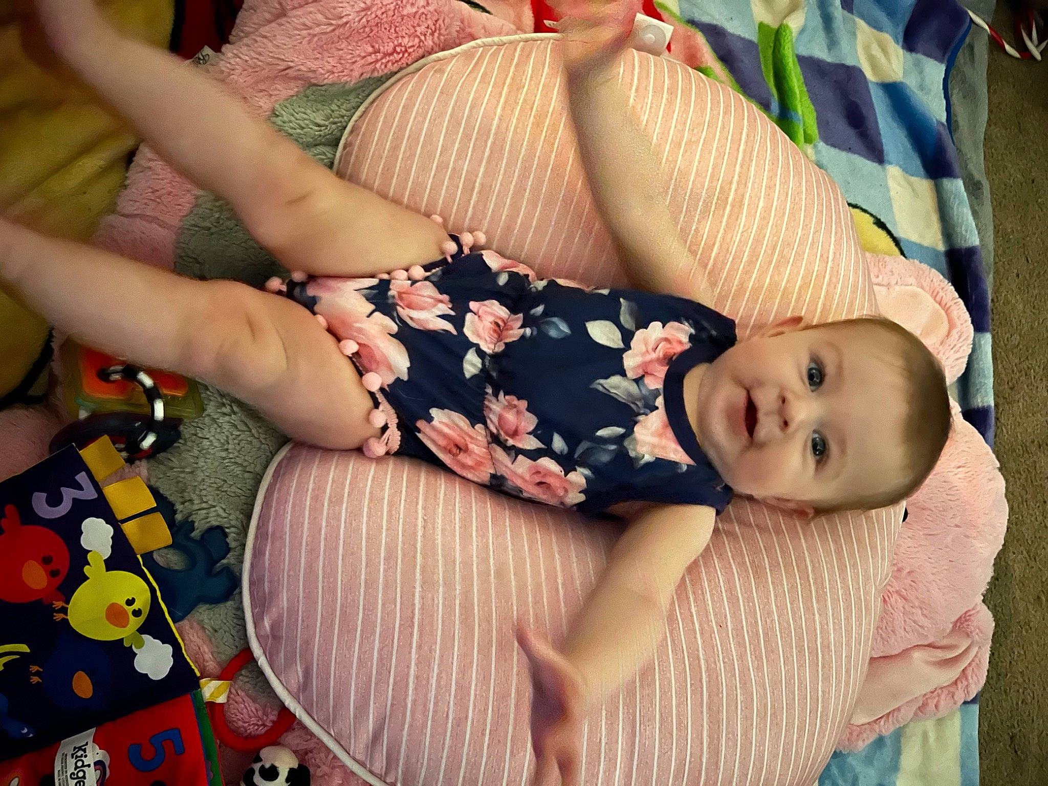 Winter is registered to the contest to win money with this photo: baby, baby_products, baby_toddler_clothing, chest, child, comfort, finger, flesh, grass, hat, human_leg, lap, linens, nail, pattern, person, plant, sitting, thigh, toddler