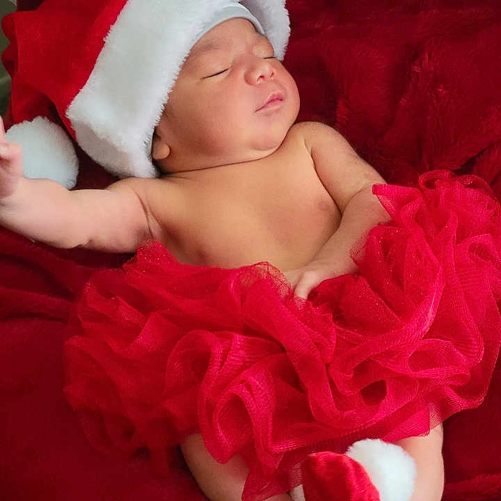 Clarissa joined the competition — help win amazing prizes! baby, blanket, child, christmas, cozy, cute, festive, footwear, holiday, holiday_outfit, holiday_theme, infant, pom_pom, portrait, red_tutu, relaxing, santa_hat, sleeping, smiling, soft_texture