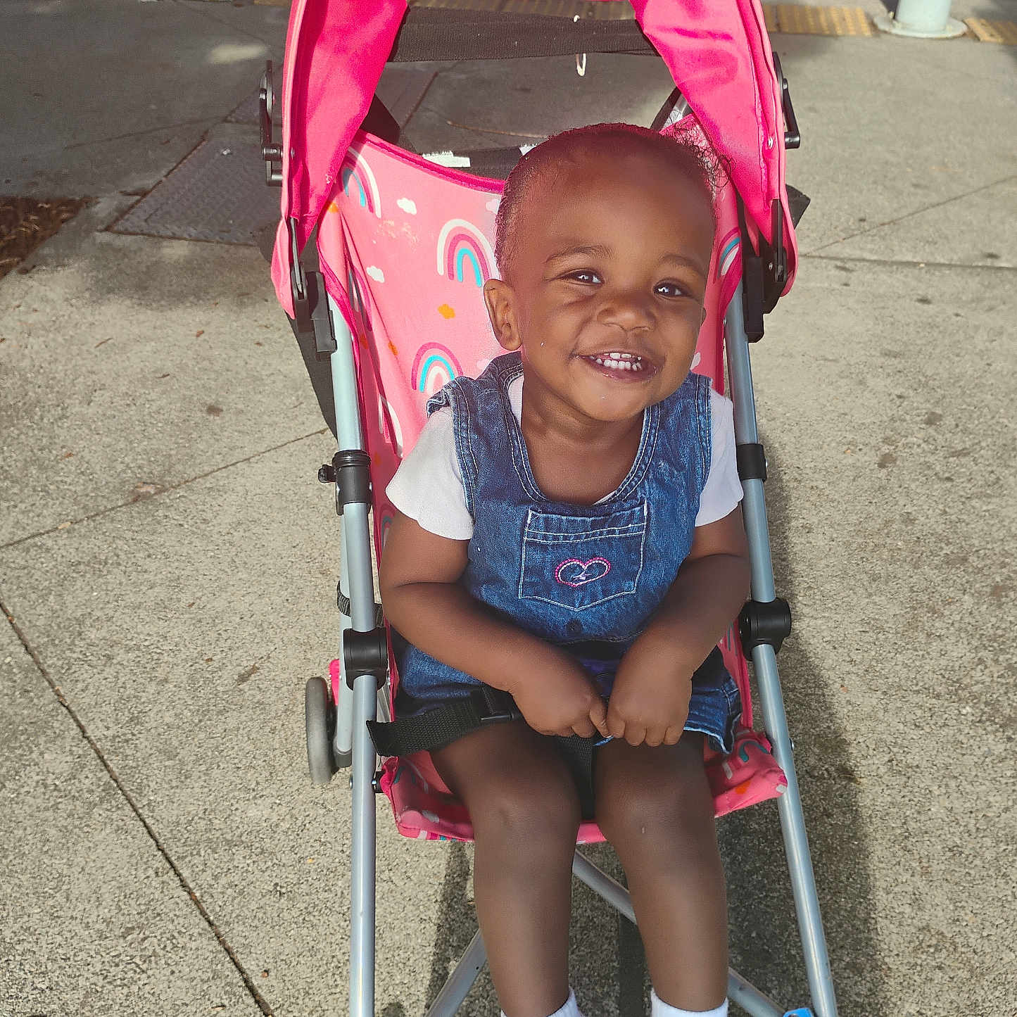 Anyia joined the competition — help win amazing prizes! baby, child, concrete, cute, daytime, denim, dress, happy, outdoor, person, pink, rainbow, seatbelt, shoes, sidewalk, smile, stroller, sunlight, toddler, white_socks