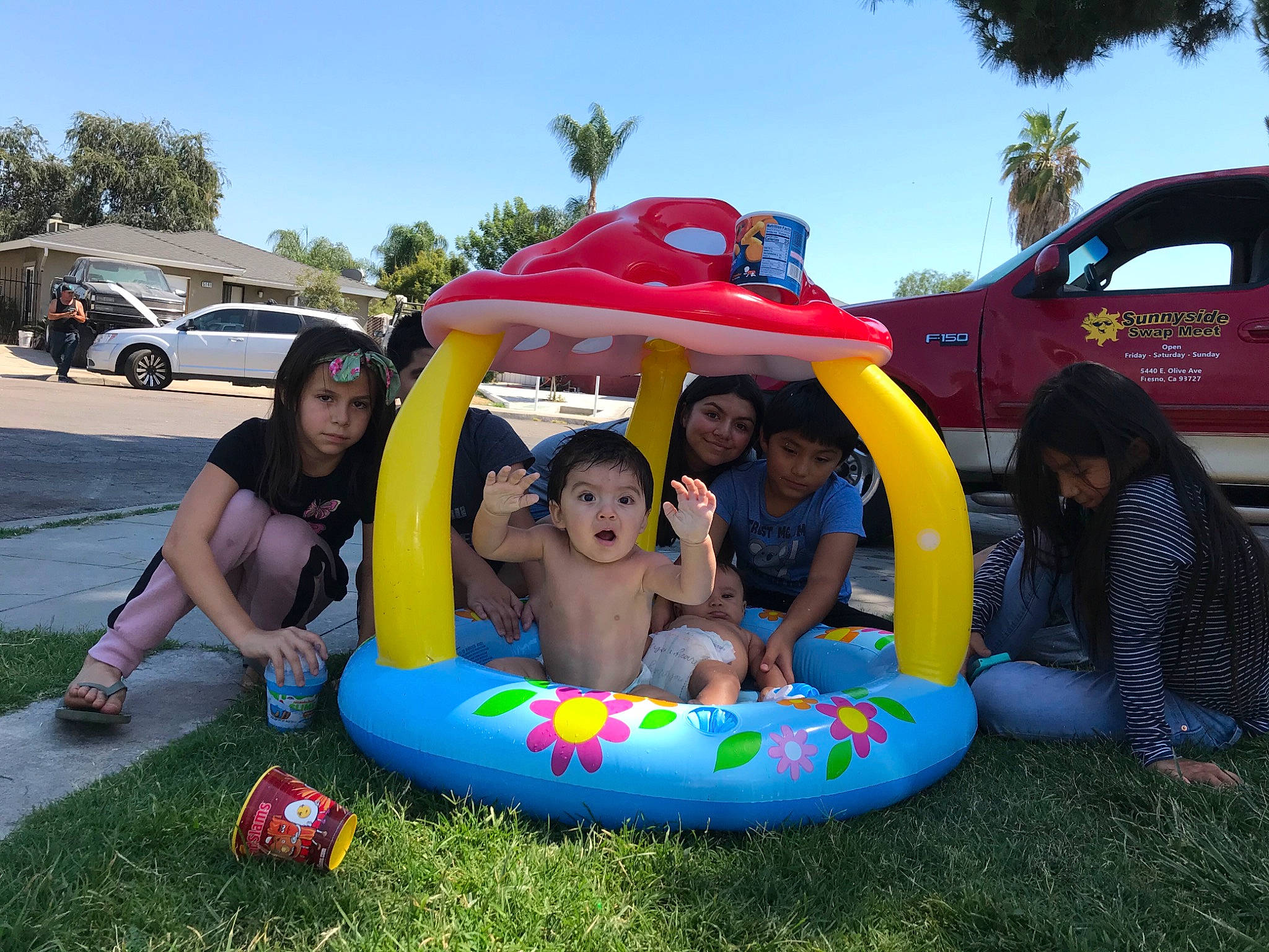 Enzo joined the competition — help win amazing prizes! automotive_exterior, bumper, car, city, event, fun, grass, headwear, inflatable, joy, land_vehicle, leisure, motor_vehicle, person, recreation, shorts, sky, smile, surprise, tire