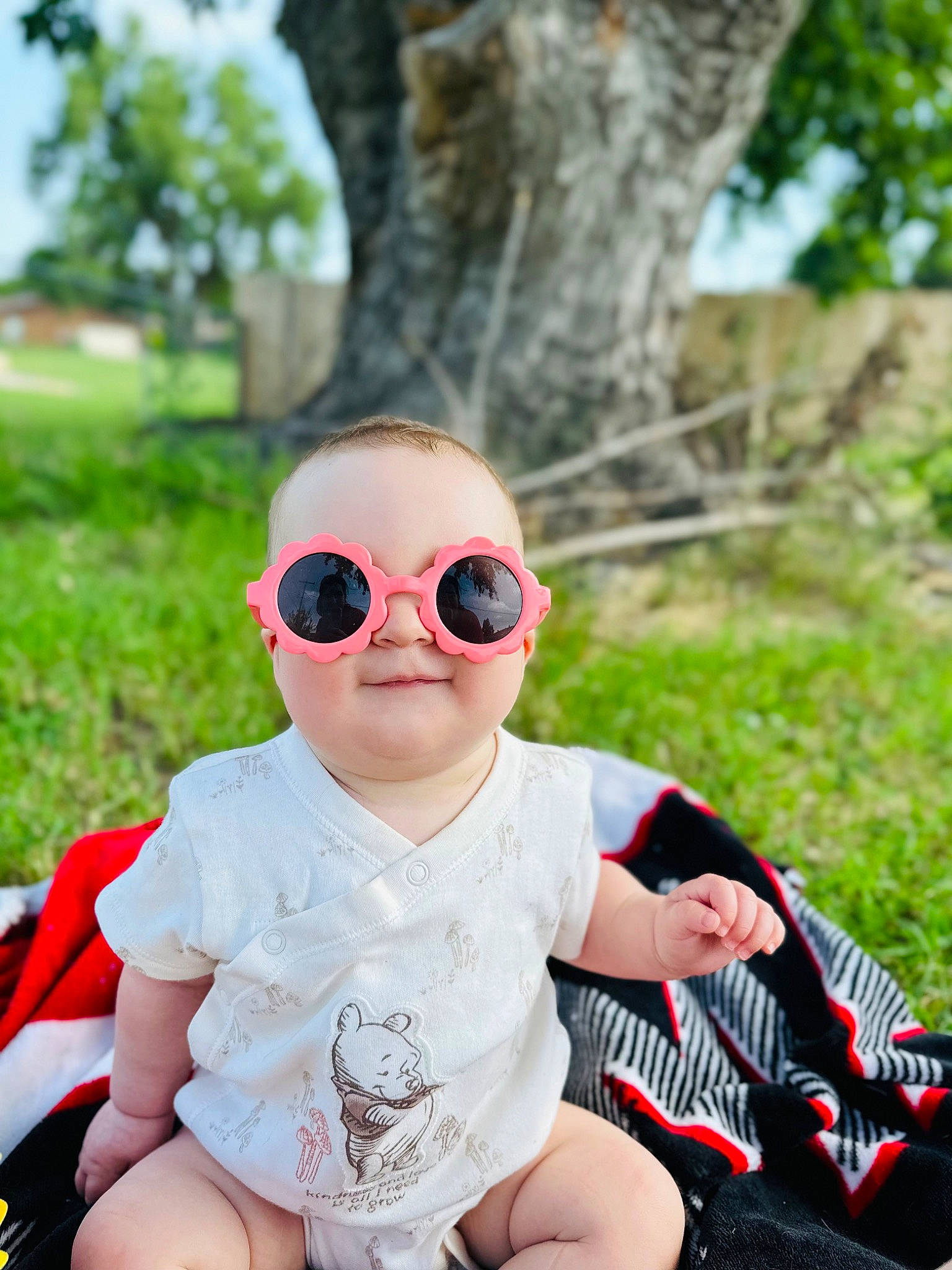 Marina joined the competition — help win amazing prizes! baby, baby_toddler_clothing, child, eyewear, fashion_accessory, glasses, goggles, grass, happy, leisure, person, personal_protective_equipment, plant, recreation, shorts, sitting, smile, sunglasses, toddler, tree