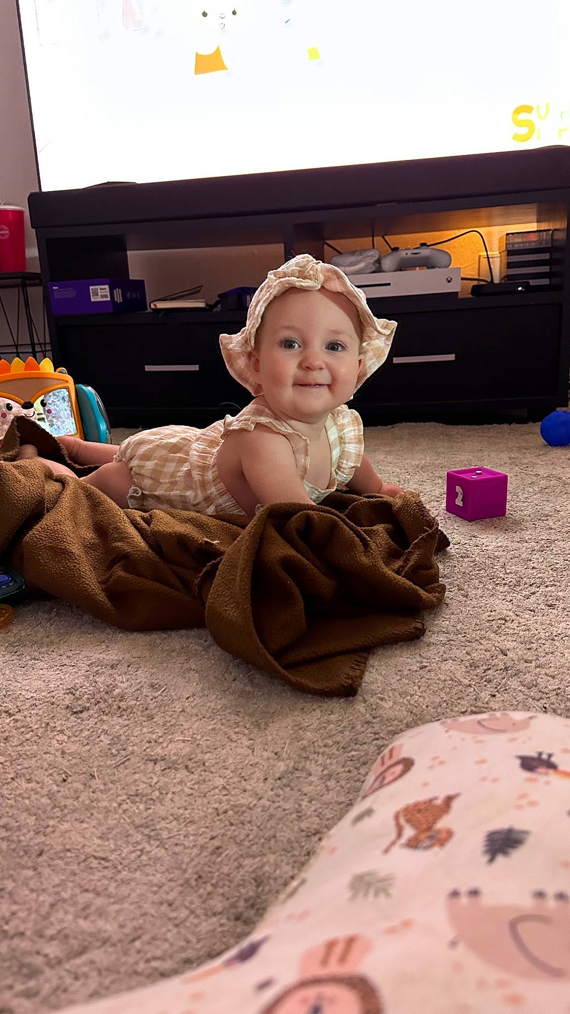 Marina joined the competition — help win amazing prizes! child, comfort, computer_keyboard, flooring, fun, gadget, hairstyle, happy, hat, helmet, human_leg, joy, lap, living_room, mammal, person, room, sitting, smile, television