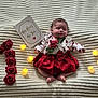 baby, infant, sleeping, red_skirt, white_shirt, roses, candles, blanket, celebration, card, number_one, flower, cute, cozy, soft_texture, portrait, indoors, peaceful, newborn, holiday