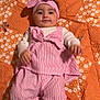 Misl E Zahra joined the competition — help win amazing prizes! baby, infant, child, pink_clothing, headband, striped, quilt, orange, floral_pattern, smiling, lying_down, cute, indoors, portrait, person, small_toes, mole, soft_lighting, fabric, comfortable