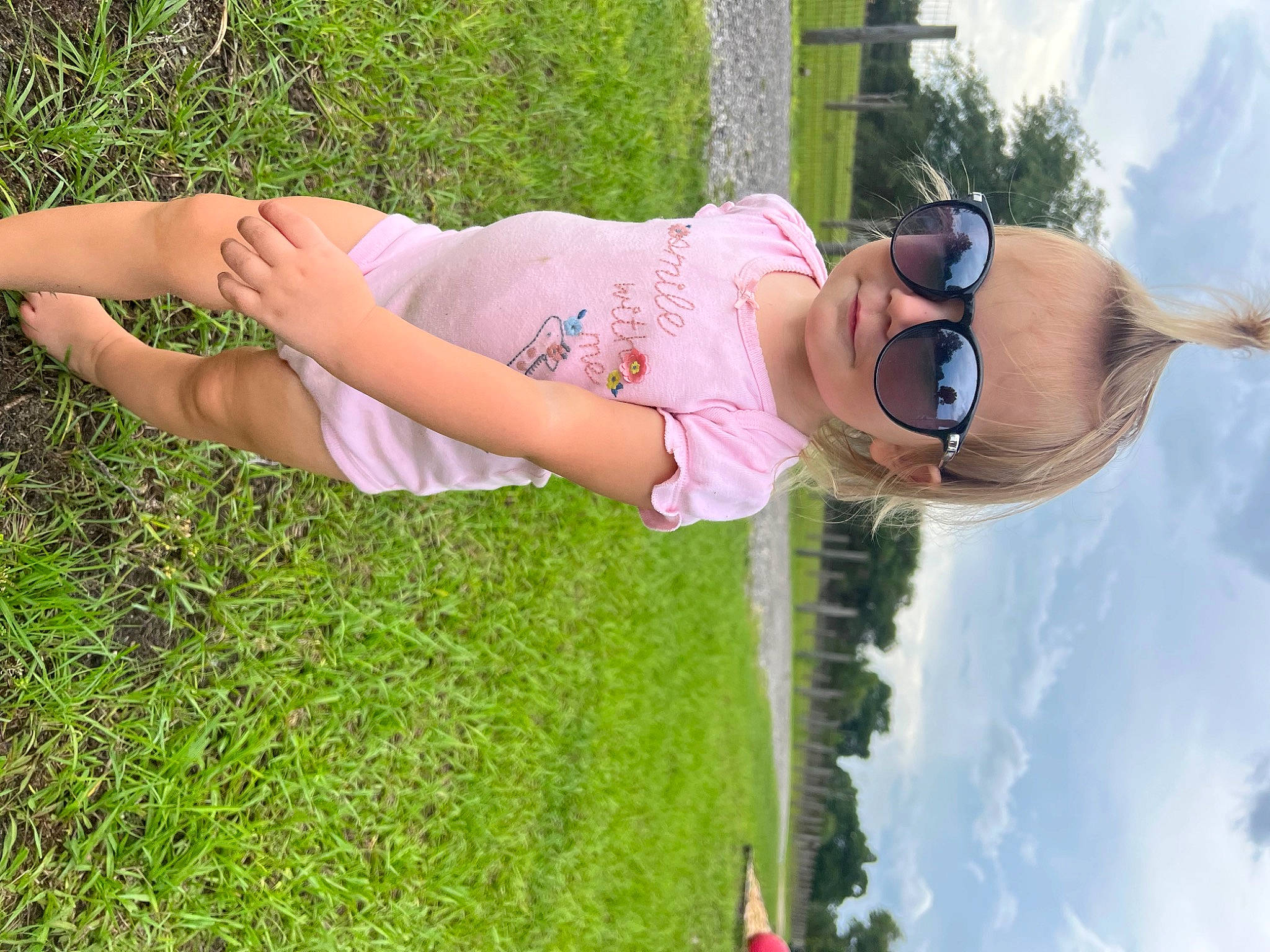 Braelyn joined the competition — help win amazing prizes! cloud, elbow, eyewear, fun, glasses, goggles, grass, grass_family, happy, human_leg, leisure, people_in_nature, person, plant, recreation, sky, smile, sunglasses, thigh, tree