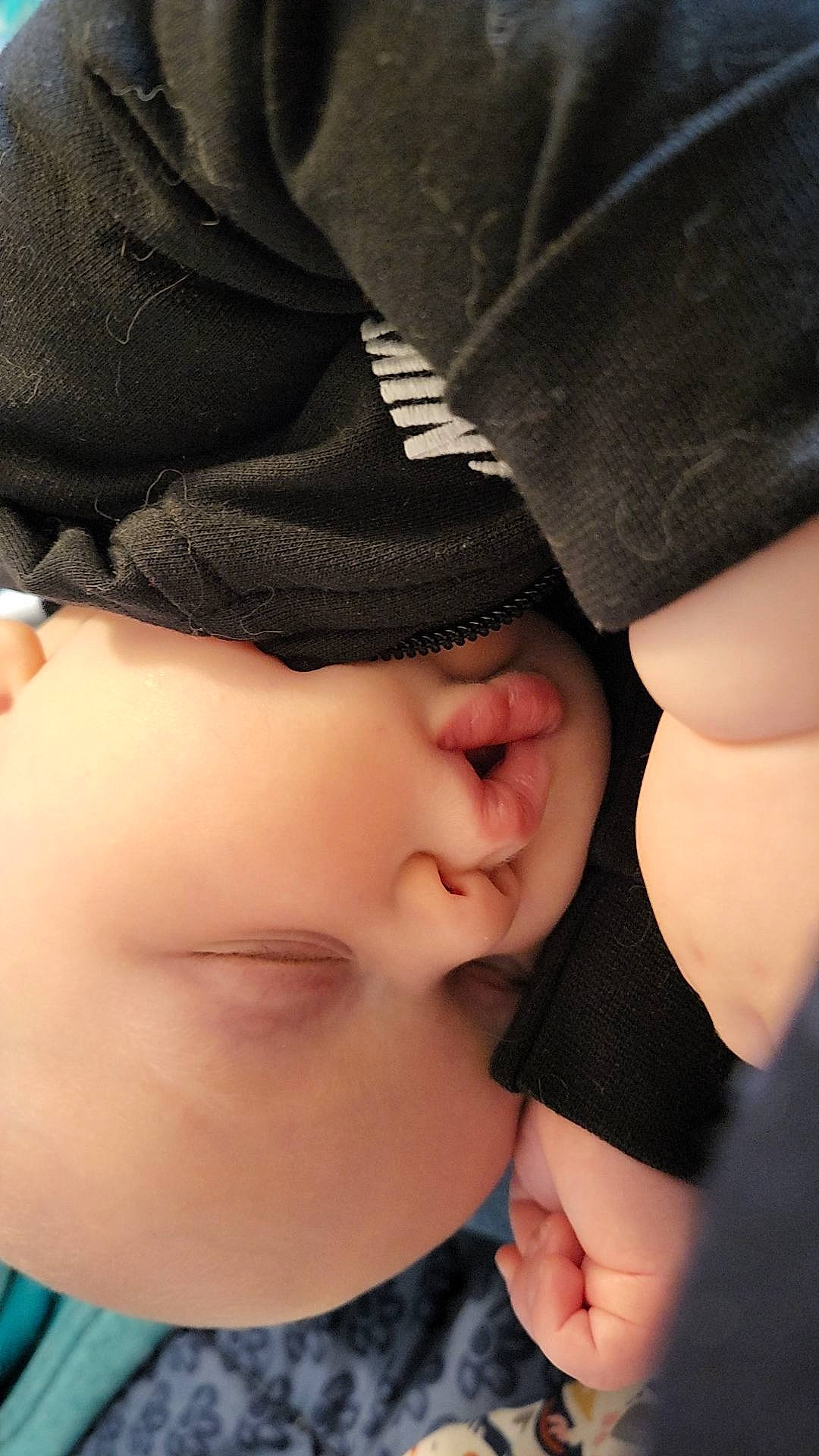 Hunter is registered to the contest to win money with this photo: baby, beauty, black_hair, cap, cheek, child, comfort, eyelash, fashion_accessory, finger, gesture, happy, human_body, lip, nail, nose, pattern, person, skin, thumb