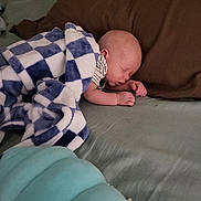 Riley joined the competition — help win amazing prizes! baby, blanket, bed, sleeping, pillow, plush_toy, blue, white, striped_clothing, infant, indoor, rest, comfort, child, soft, cute, peaceful, toddler, sleep, young