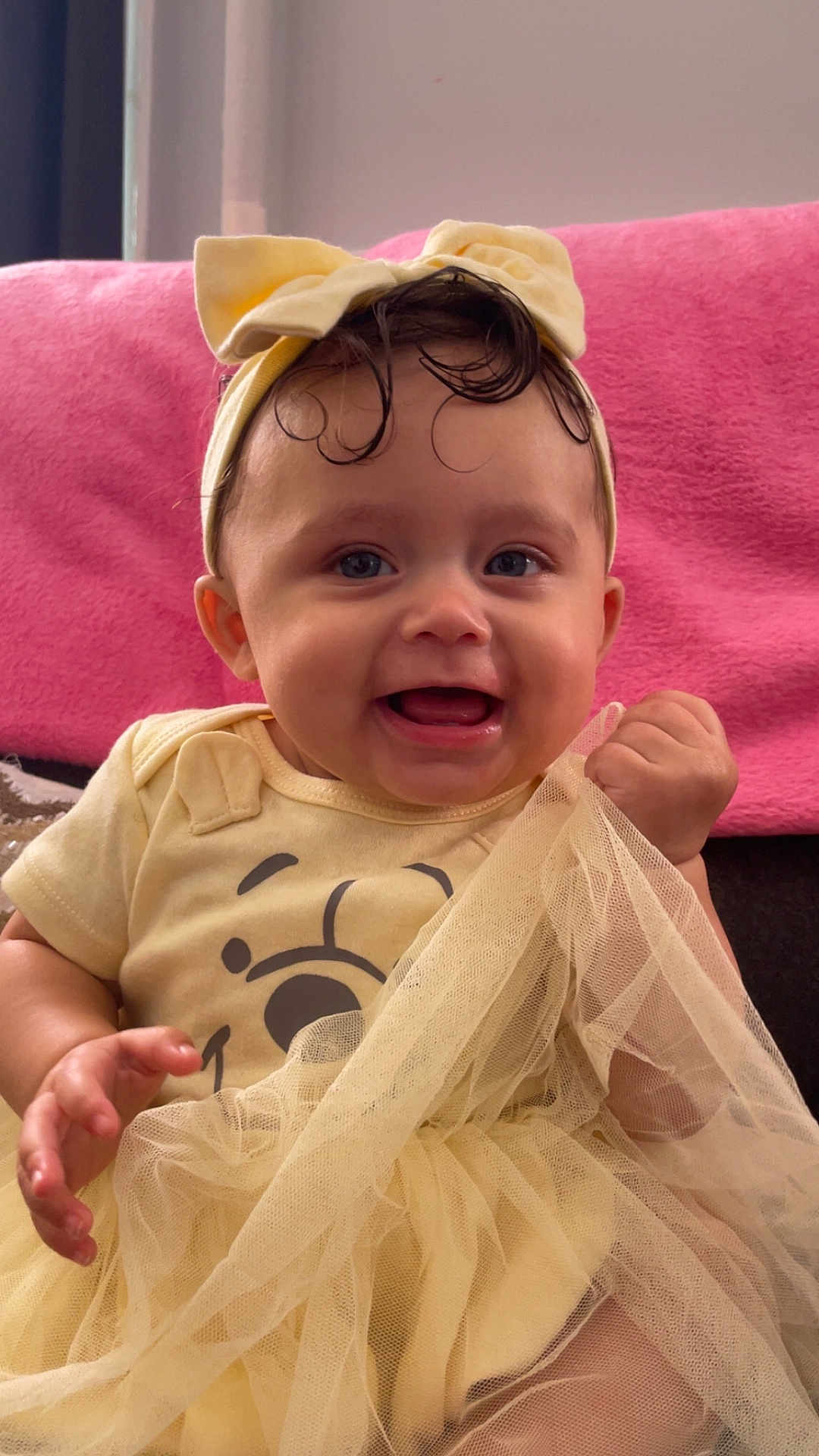 Xiyalize Royalty is registered to the contest to win money with this photo: baby, child, smiling, yellow_outfit, headband, tulle, fabric, happy, cute, indoor, portrait, sitting, pink_background, clothing, toddler, face, hands, expression, person, infant