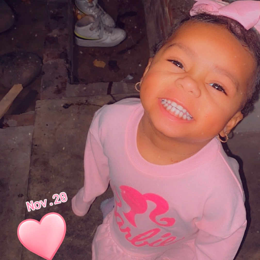 Jaylah is registered to the contest to win money with this photo: baby, bodypart, clothing, face, finger, footwear, hand, happy, head, heart, mouth, pants, person, photography, portrait, shoe, smile, symbol, t_shirt, teeth