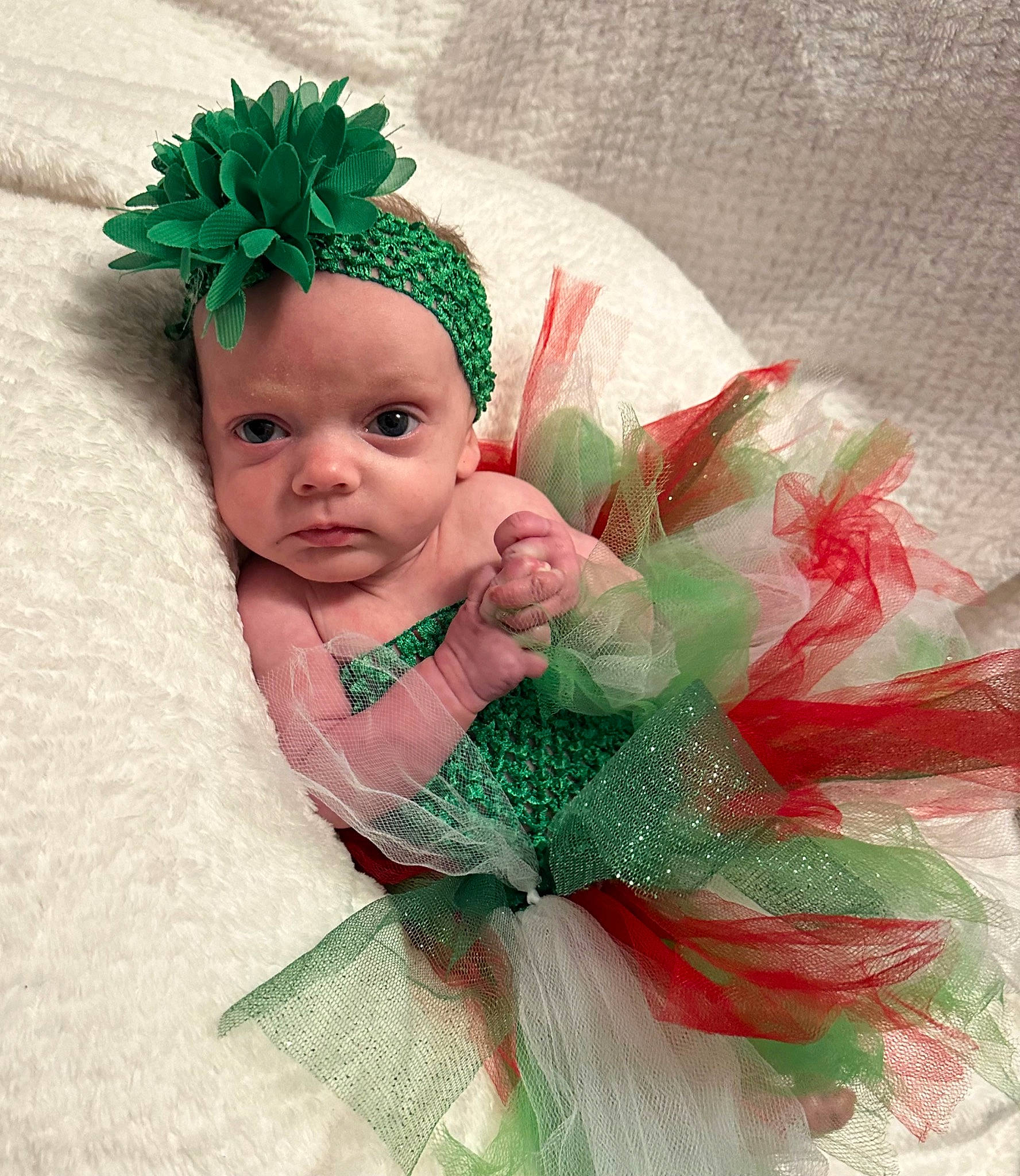 Harper is registered to the contest to win money with this photo: baby, baby_toddler_clothing, costume_hat, event, eye, face, fashion_accessory, fictional_character, grass, happy, head, headband, headgear, headpiece, headwear, human_body, jewellery, linens, person, pink