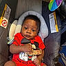 Jasaiah joined the competition — help win amazing prizes! baby, infant, car_seat, red_clothing, mickey_mouse, pacifier, curly_hair, cushion, warning_label, colorful_fan, child, portrait, indoors, seatbelt, person, cute, expression, comfort, hand, clothing