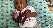 Jasaiah joined the competition — help win amazing prizes! baby, infant, pillow, blue, bear_pattern, mask_pattern, white_shirt, aeropostale, grey_pants, sneakers, jordan_shoes, smiling, cute, indoors, bedroom, blanket, child, young, happy, person