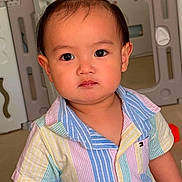 Kavien joined the competition — help win amazing prizes! baby, background, casual_clothing, child, colorful_clothing, curious, cute, expression, face, home, indoor, person, play_area, portrait, short_sleeves, standing, striped_shirt, toddler, topknot, young_child