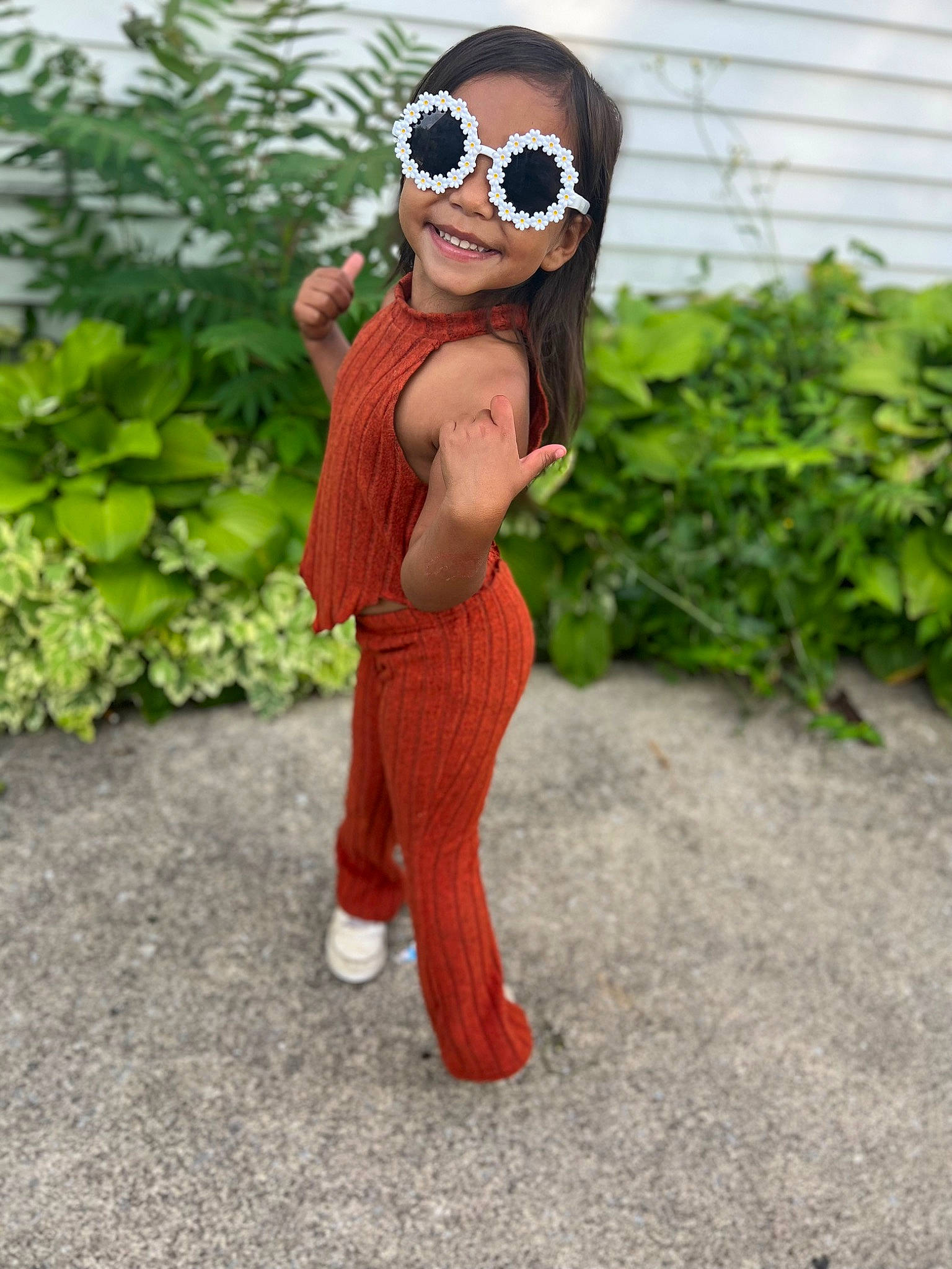 Laityn is registered to the contest to win money with this photo: child, eyewear, fun, garden, glasses, goggles, grass, happy, hat, headgear, joy, lawn_ornament, leisure, magenta, outerwear, person, personal_protective_equipment, plant, sleeve, smile