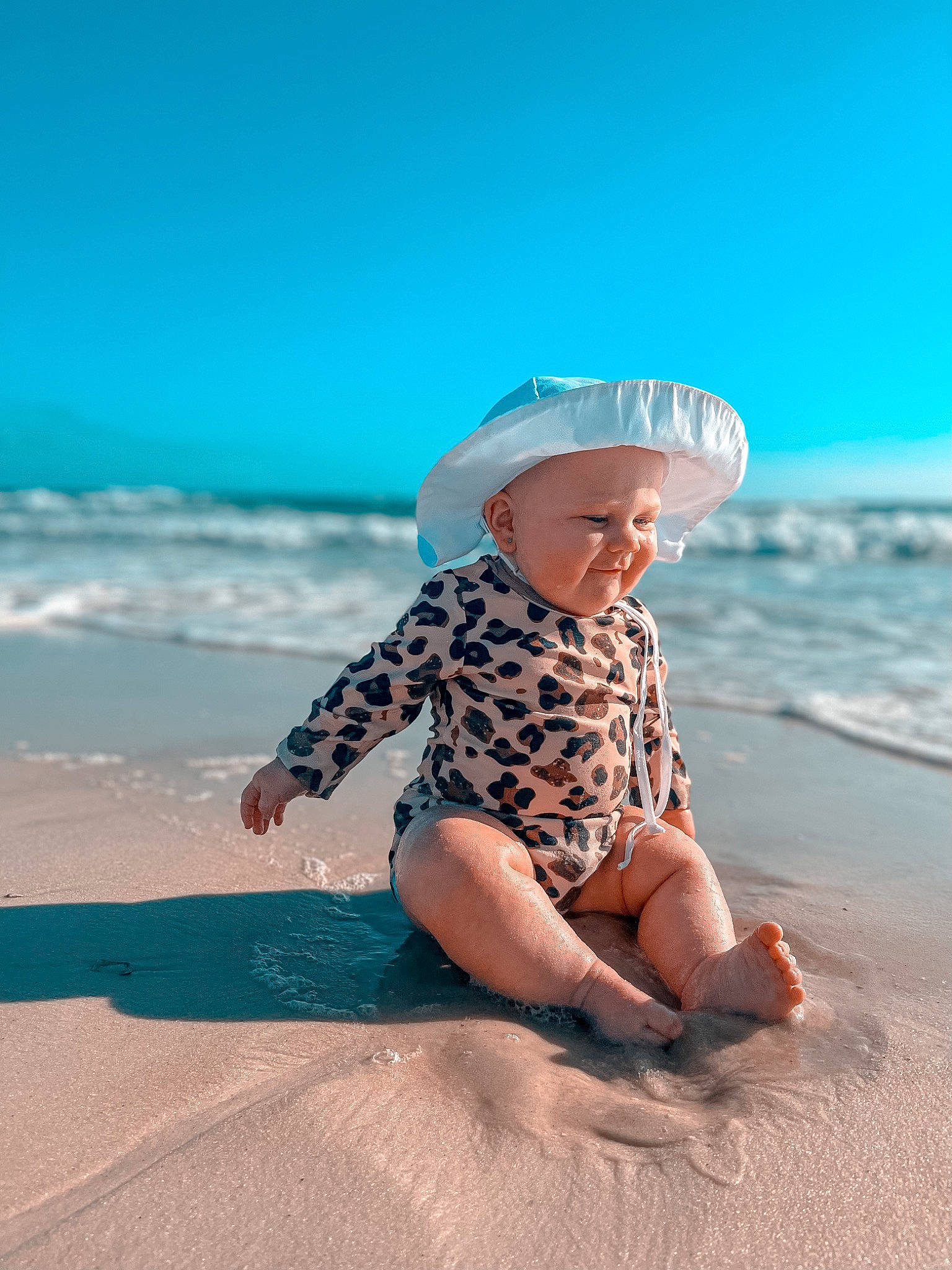 Saylor joined the competition — help win amazing prizes! baby, beach, cloud, coastal_and_oceanic_landforms, fun, happy, hat, horizon, landscape, leisure, people_in_nature, people_on_beach, person, sand, shore, sky, sun_hat, toddler, travel, water