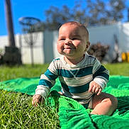 Layla joined the competition — help win amazing prizes! baby, child, grass, outdoor, sunlight, green_blanket, smile, happy, portrait, infant, nature, blue_sky, striped_clothing, crawling, play, cute, young_child, backyard, sunny, cheerful