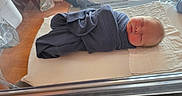 Tommie joined the competition — help win amazing prizes! baby, bassinet, bed, blanket, cozy, face, healthcare, hospital, human, indoor, infant, newborn, peaceful, person, quiet, resting, sleeping, soft_light, swaddle, wrapped