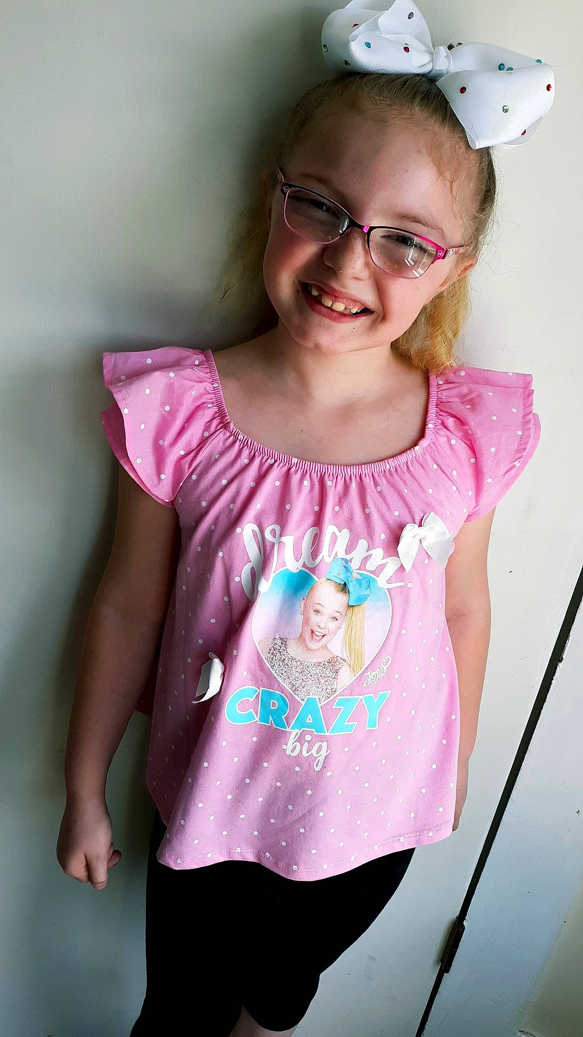Jadyn is registered to the contest to win money with this photo: blouse, child, child_model, clothing, glasses, joy, magenta, neck, pattern, person, pink, shoulder, sleeve, t_shirt, toddler, top